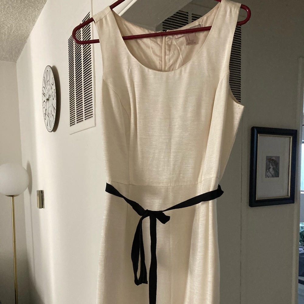 Knee-length beige dress with black sash
